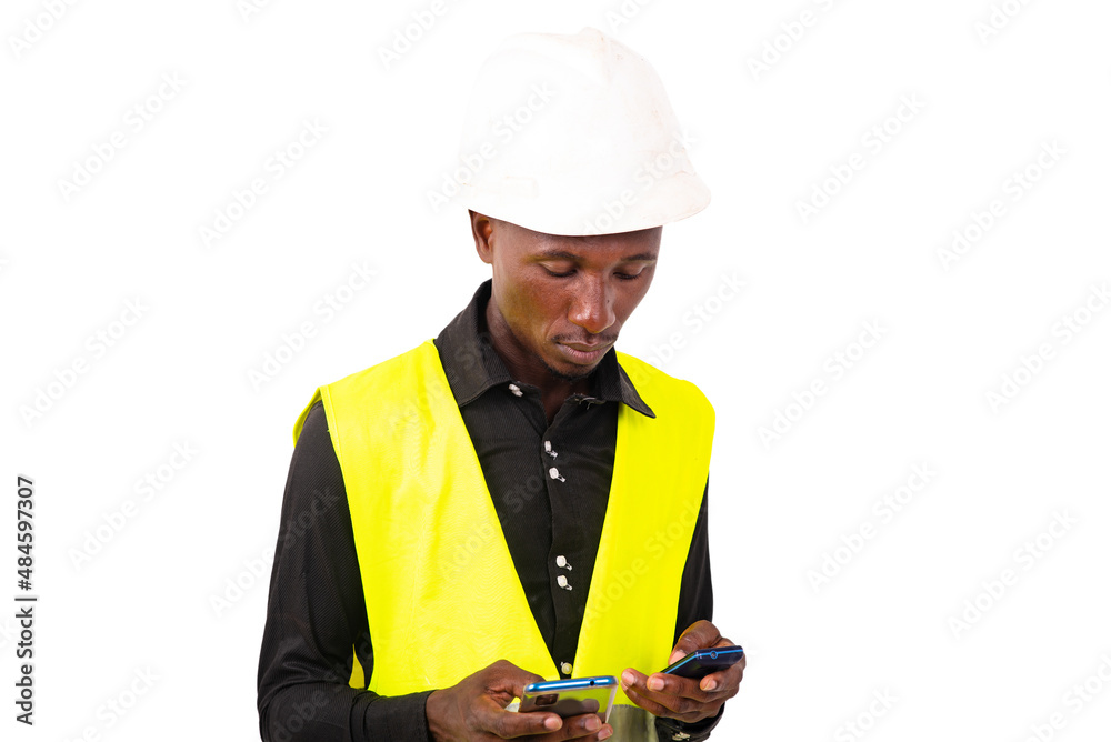 young man engineer holding two mobile phones. young man engineer holding two mobile phones.