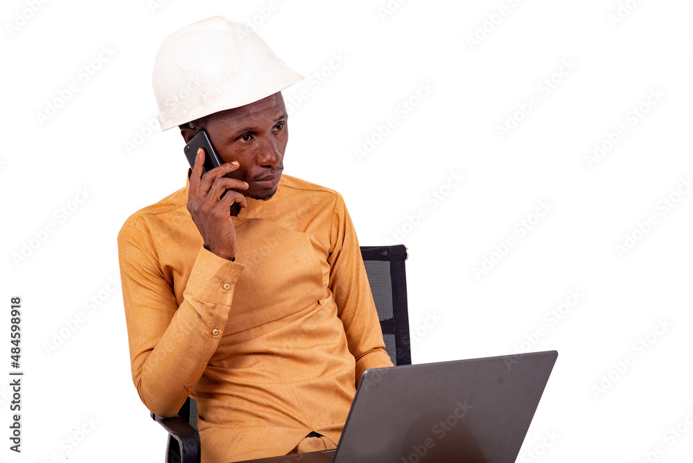 young business man engineer talking on mobile phone using laptop. young business man engineer talking on mobile phone using laptop.