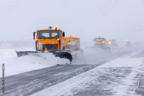 Snow plow on the runway in a snowstorm