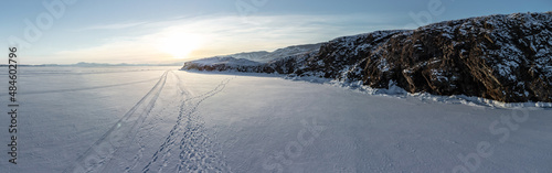 Beautiful landscape of winter snow-covered Lake Baikal and the surrounding mountains. Bird s-eye view