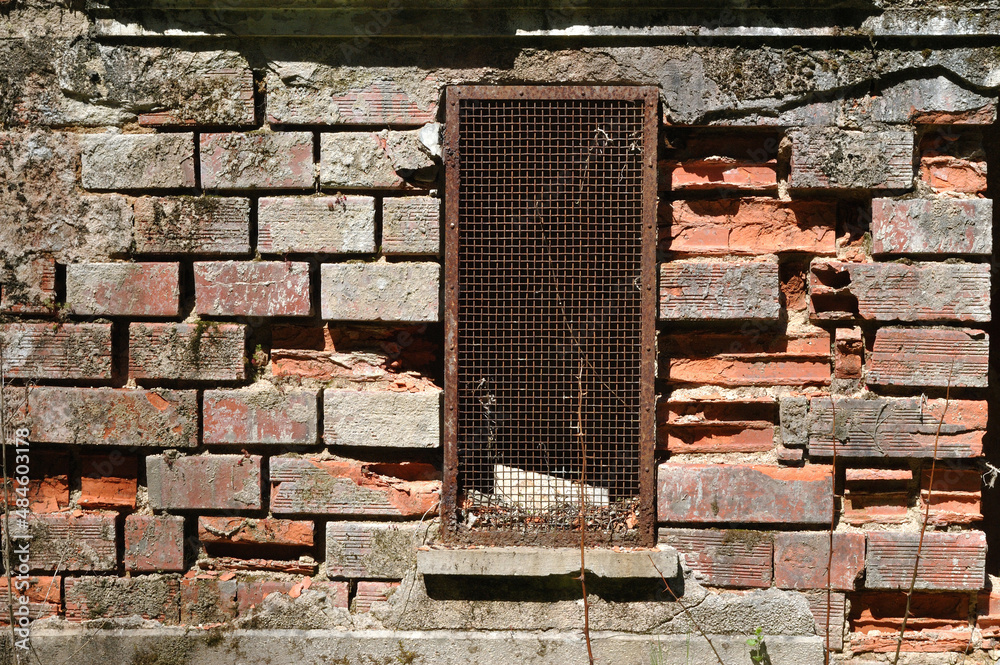Old Rusty Iron Grill over Window in Derelict Brick Building Old Rusty Iron Grill over Window in Derelict Brick Building
