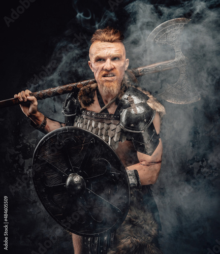 Violent viking with shield and axe posing in smoke © Fxquadro
