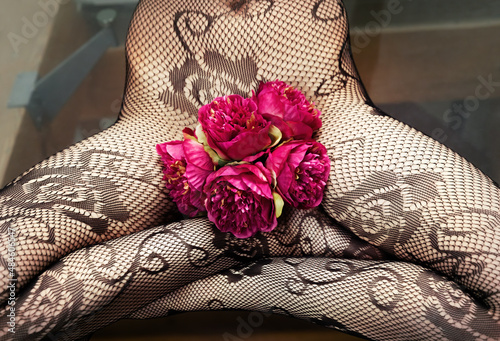 Woman in fishnet tights with pink peonies