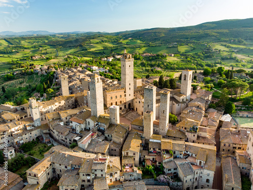 Aerial view of famous medieval San Gimignano hill town with its skyline of medieval towers, including the stone Torre Grossa. UNESCO World Heritage Site. photo