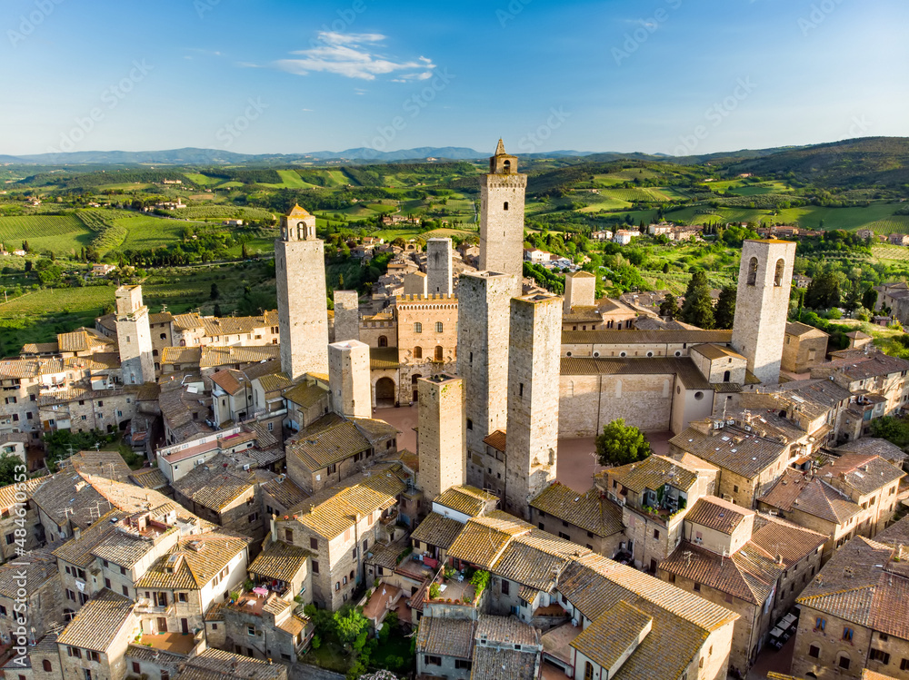 Aerial view of famous medieval San Gimignano hill town with its skyline of medieval towers, including the stone Torre Grossa. UNESCO World Heritage Site.