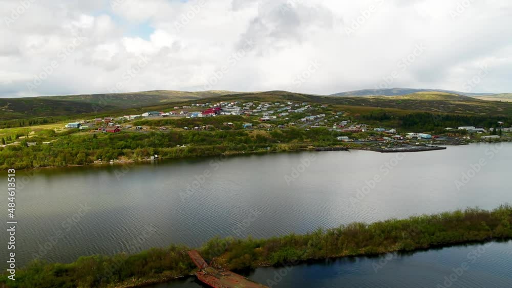 Aerial Scenic Shot Of Houses On Green Hills With A Drone Flying Forward Over River - Saint Mary's, Alaska Aerial Scenic Shot Of Houses On Green Hills With A Drone Flying Forward Over River - Saint Mary's, Alaska
