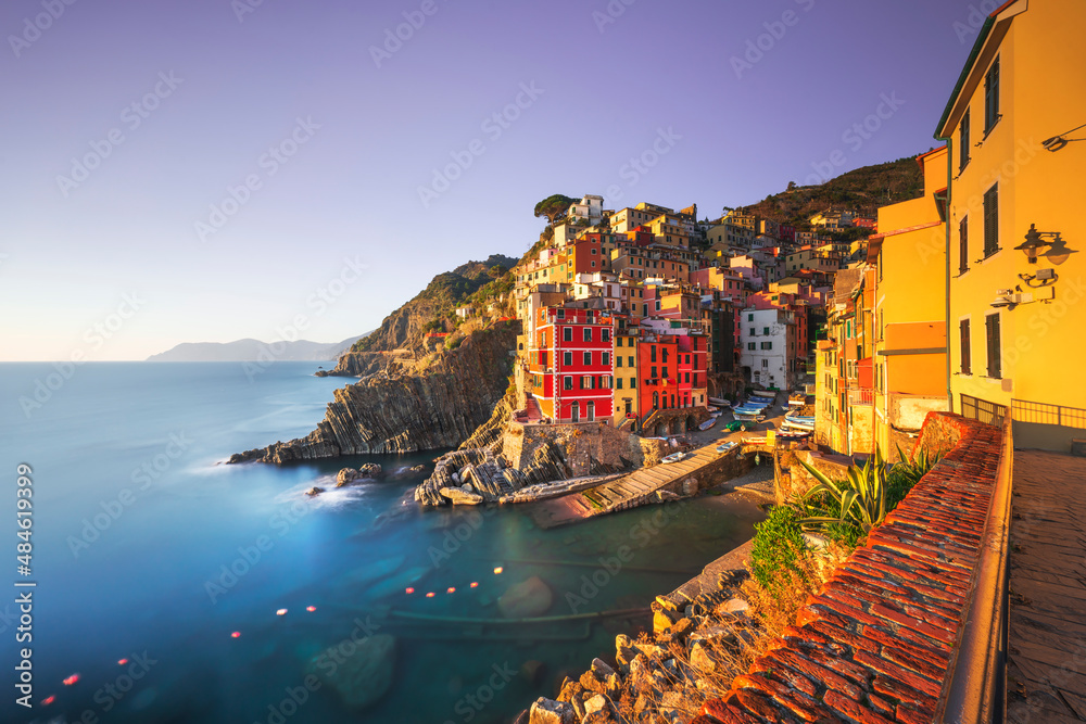 Riomaggiore town, cape and sea at sunset. Cinque Terre, Liguria, Italy