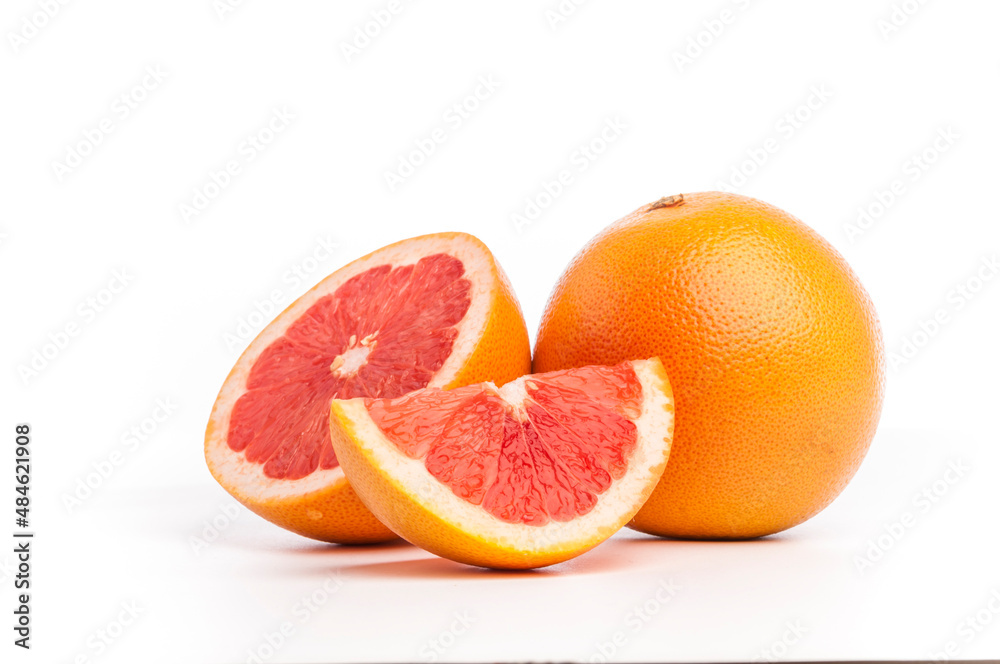 Slices of fresh grapefruit along with whole fruit. Fruits with goodness of vitamin C. Slices of fresh grapefruit along with whole fruit. Fruits with goodness of vitamin C.