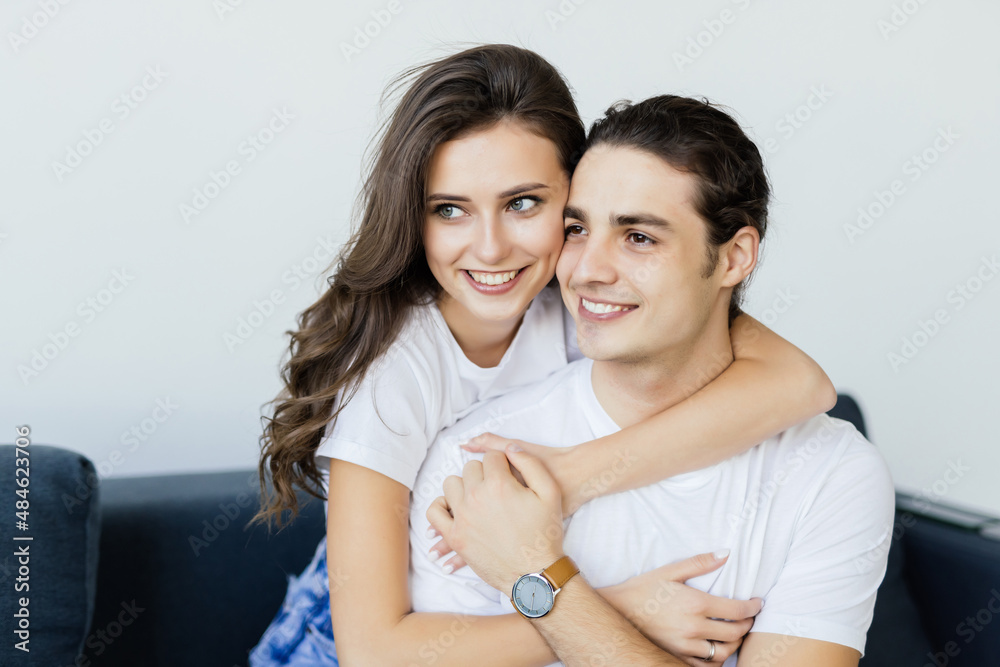 Beautiful couple, holding hands, posing for camera at home Beautiful couple, holding hands, posing for camera at home