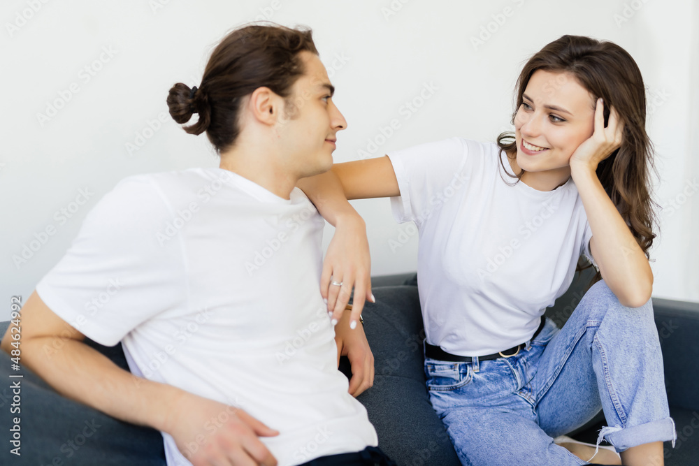 Loving couple talking to each other at home Loving couple talking to each other at home
