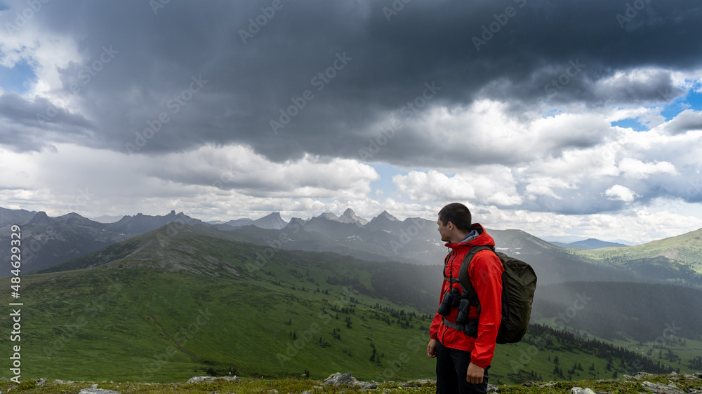 Naklejka premium Man hiking with heavy backpack travel lifestyle wandering adventure concept summer vacation outdoors alone in the wild