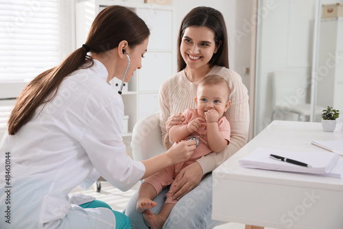 Mother with her cute baby visiting pediatrician in clinic photo