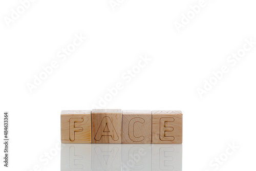 Wooden cubes with letters face on a white background