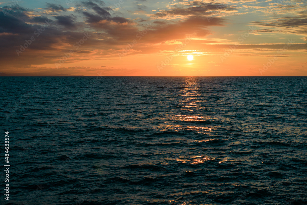 seascape during sunset, horizon line and setting sun