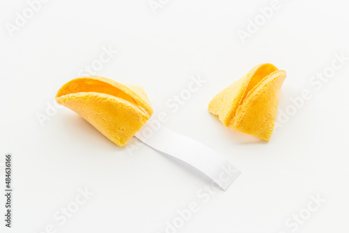 Broken Chinese fortune cookie with blank slip outside