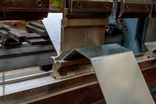 Bending of sheet metal parts using a bending machine. Production of metal parts.