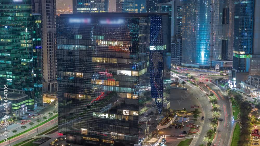 Business Bay Dubai skyscrapers with traffic on road intersection aerial night timelapse. Business Bay Dubai skyscrapers with traffic on road intersection aerial night timelapse.