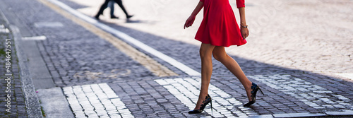 beautiful girl legs while crossing the road on the crosswalk