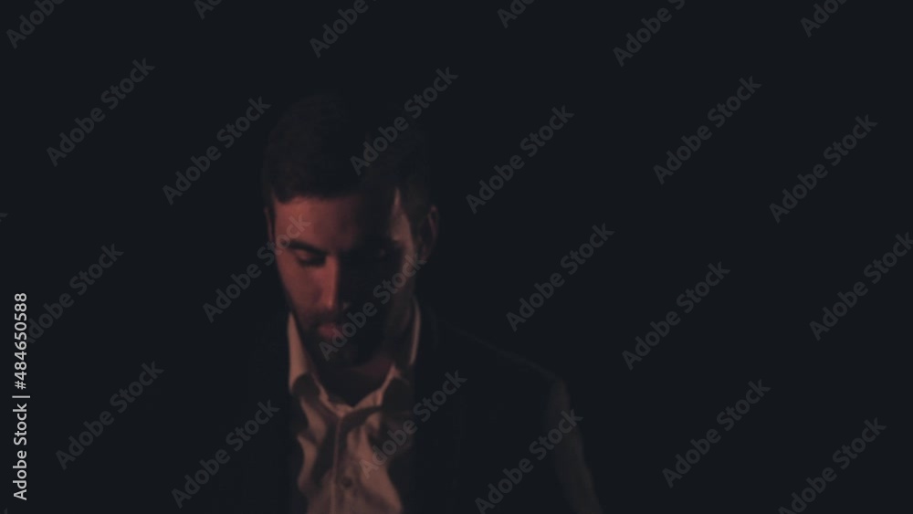 4k slow motion video of a man wearing black suit on black background. 4k slow motion video of a man wearing black suit on black background.