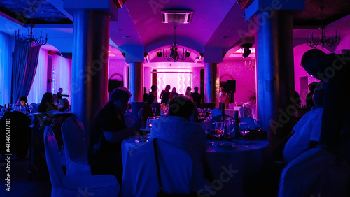 Party in neon light in the hall of the restaurant