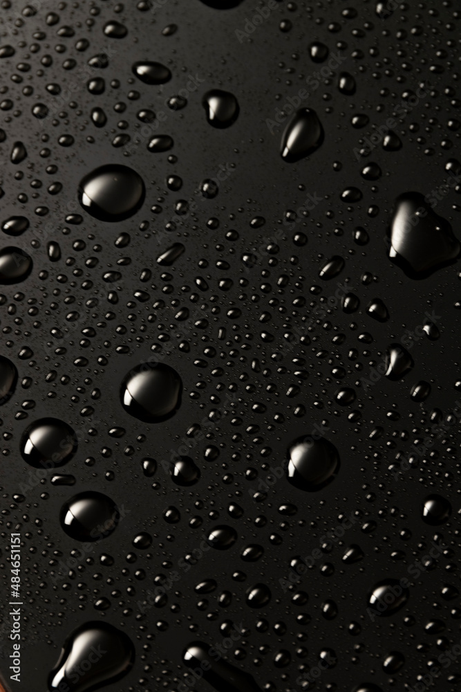 Black metal water drops on dark reflective surface Black metal water drops on dark reflective surface