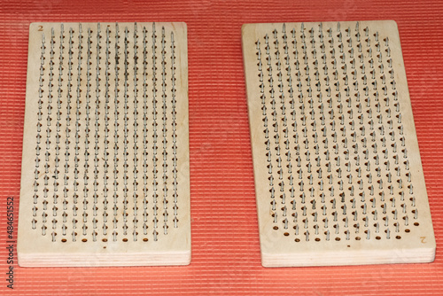 Pair of brown Sadhu boards on a red background