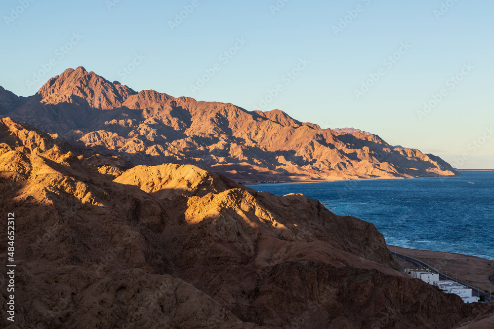 Aerial view of Sinai mountains and Red Sea at sunset. Dahab town, Sinai peninsula, Egypt