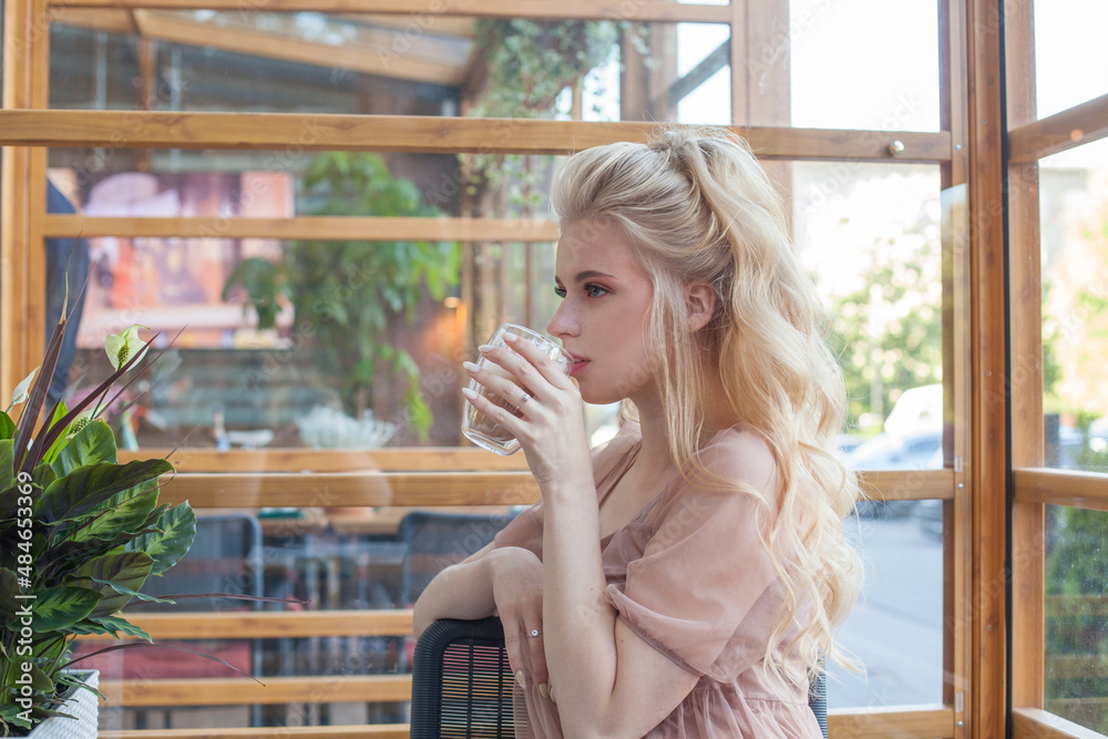 Fototapeta premium Portrait of attractive young woman drinking coffee