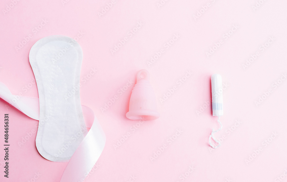 Obraz premium Menstrual cup, tampon, woman cup for sanitary protection. Pink ribbon with menstrual cup. Menstruation feminine period. Zero waste concept, ecofriendly lifestyle, reduced banner consumption.