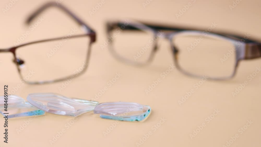 eyeglass with broken glass on table 
