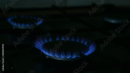 Lit three gas burners on the kitchen stove. The blue flame burns a household gas stove, then all the comforts go out.