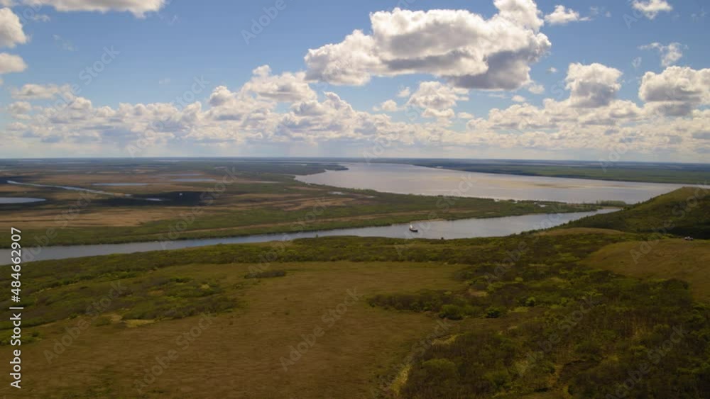 Aerial Scenic Shot Of Boat Moored In River, Drone Flying Forward Over Hills Landscape - Saint Mary's, Alaska Aerial Scenic Shot Of Boat Moored In River, Drone Flying Forward Over Hills Landscape - Saint Mary's, Alaska