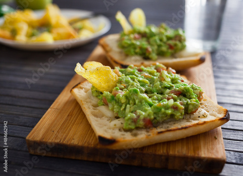 toasted slices of square bread with warm cheese and homemade guacamole on plate for healthy breakfast