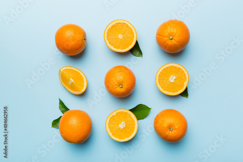 Fruit pattern of fresh orange slices on colored background. Top view. Copy Space. creative summer concept. Half of citrus in minimal flat lay