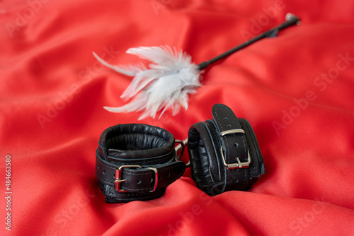 Photography Accessories for bdsm on a red satin fabric background