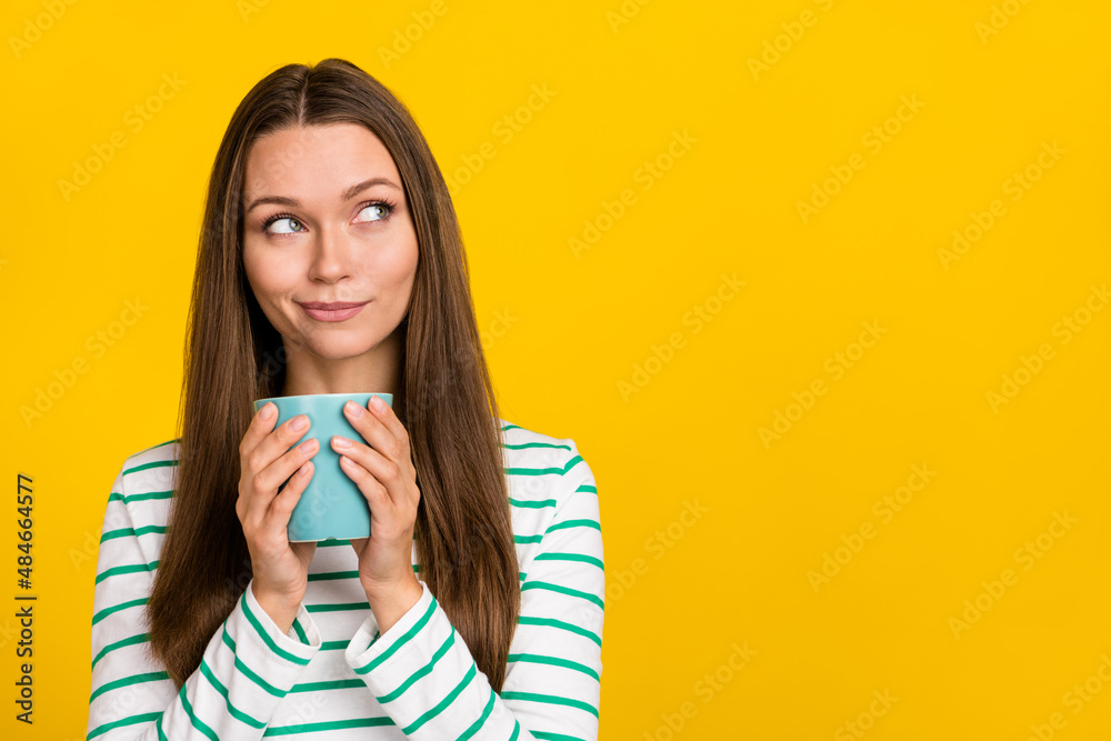 Photo of dreamy cute young woman wear striped shirt drinking looking empty space isolated yellow color background - obrazy, fototapety, plakaty 