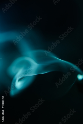 Green smoke pattern, beautiful puffs of smoke from cigarettes and hookah in the dark © Наташ Сергеева