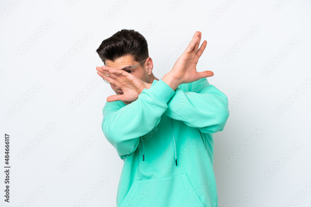 Young handsome caucasian man isolated on white bakcground nervous stretching hands to the front Young handsome caucasian man isolated on white bakcground nervous stretching hands to the front