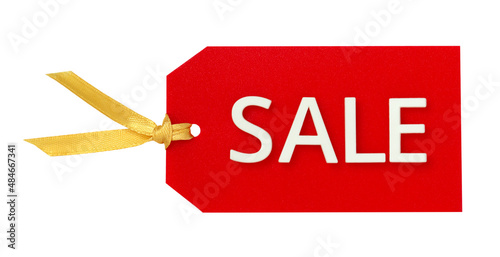 sale. red tag with white lettering and gold ribbon. horizontal orientation