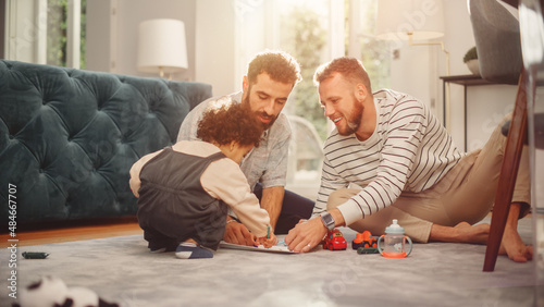 Obraz na płótnie Loving LGBTQ Family Playing with Toys with Adorable Baby Boy at Home on Living Room Floor