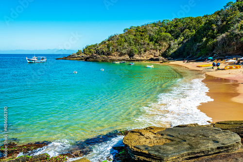 Paradise beach with colorful transparent waters surrounded by stones and vegetation in the city of Buzios  one of the main tourist destinations in Rio de Janeiro