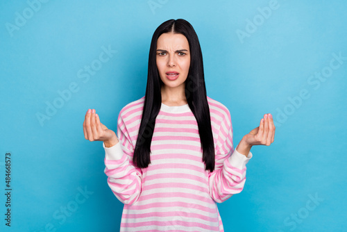 Photo of young woman displeased conflict show fingers ask money bankrupt isolated over blue color background