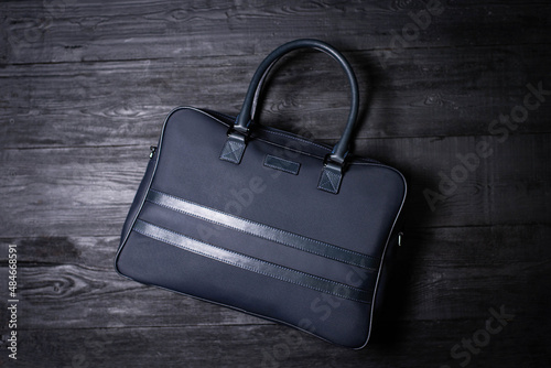 classic men's bag made of blue leather on a dark background