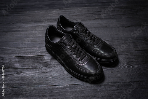 black men's shoes on a dark background