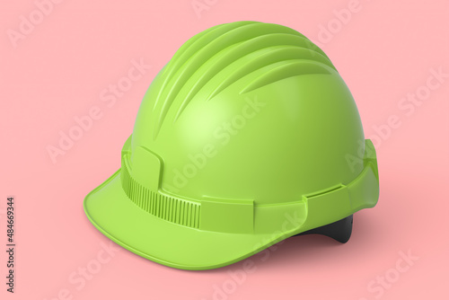 Green safety helmet or hard cap isolated on pink background