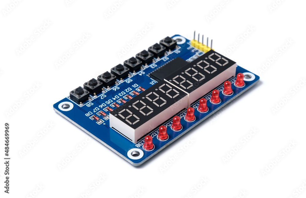 Microcircuit with buttons, display and red LEDs isolated on white background. Microcircuit with buttons, display and red LEDs isolated on white background.