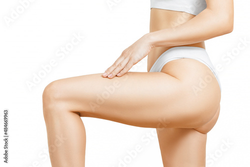 Closeup view of young woman touching skin, isolated on white.