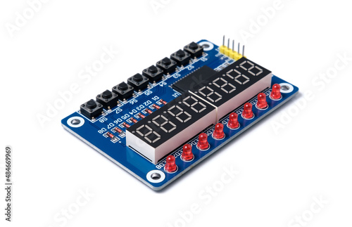 Microcircuit with buttons, display and red LEDs isolated on white background.