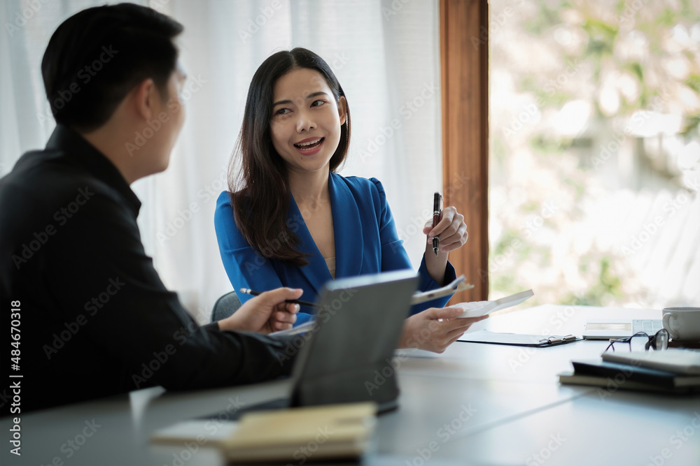 Two business asian Talking Discussing with coworker planning analyzing financial document data charts and graphs in Meeting and successful teamwork Concept. Two business asian Talking Discussing with coworker planning analyzing financial document data charts and graphs in Meeting and successful teamwork Concept.