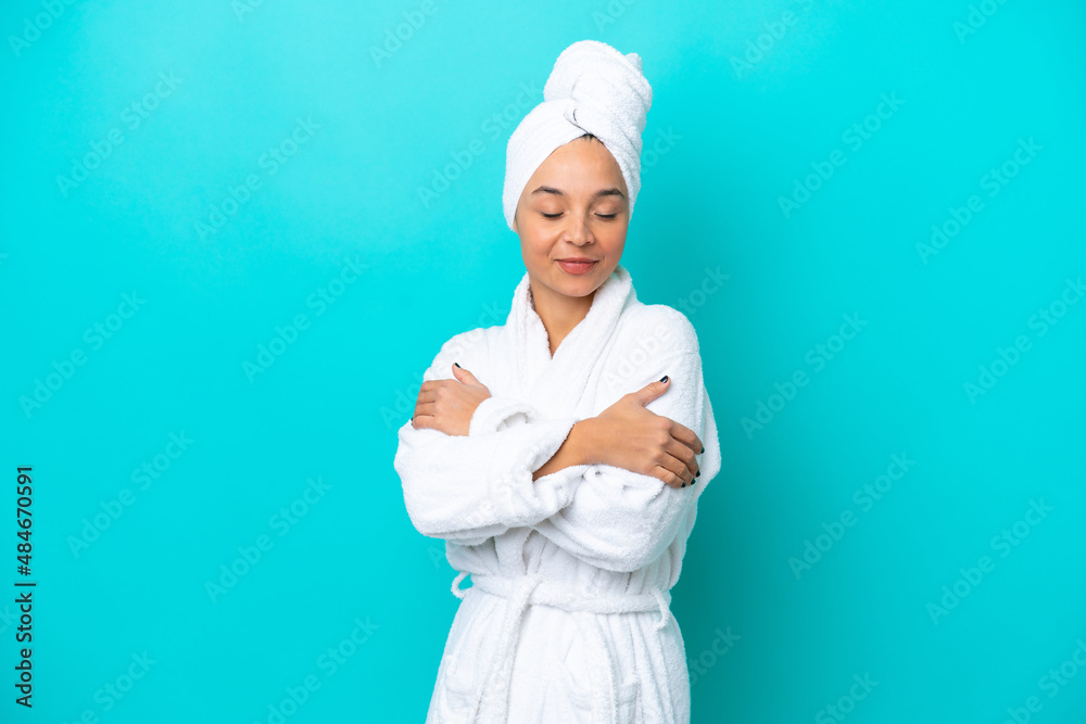 Young woman in a bathrobe with towel isolated on blue background Young woman in a bathrobe with towel isolated on blue background